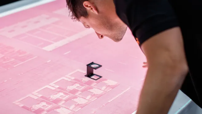 Checking print quality with a magnifier at Rivendell
