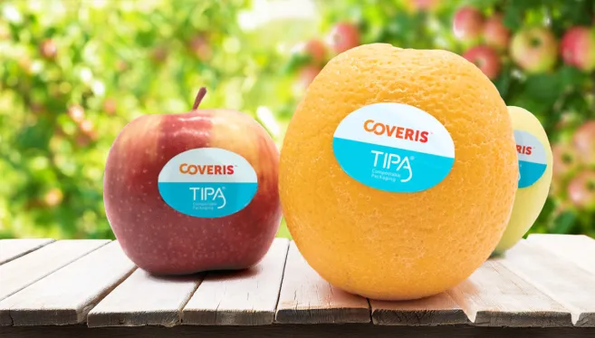 Apple and orange with TIPA home compostable fruit labels by Coveris