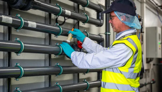 Employee at the ReCover water treatment system